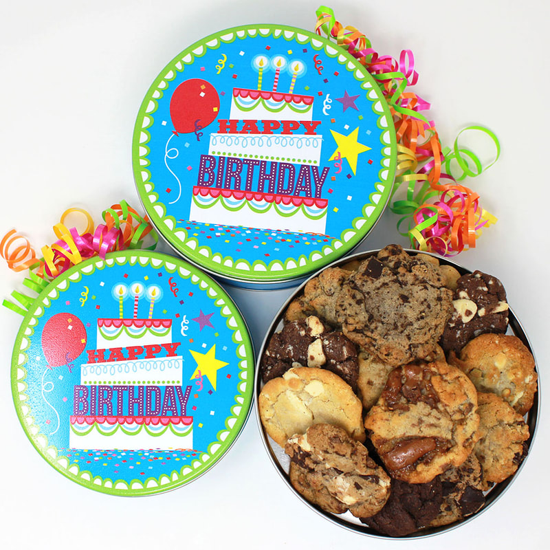 Felix & Norton Cookies - Birthday Cake Tin. Vivid blue background with lime green border and a layered birthday cake with text "Happy Birthday"