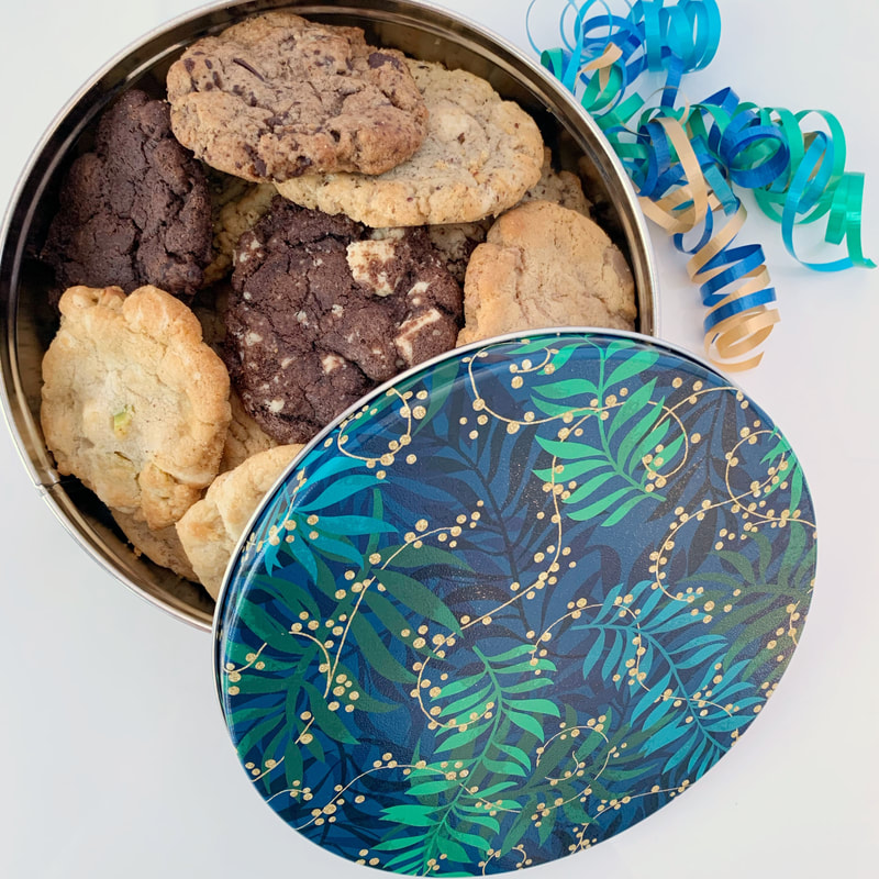 Felix & Norton Cookies - Tropical Nights Tin. Greenery in shades of blue and green mixed with golden berries on vines.